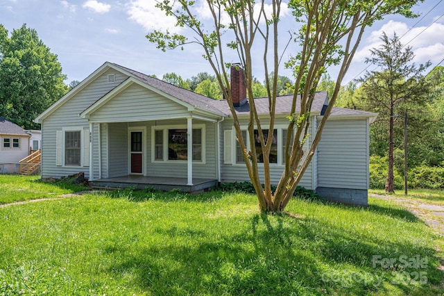 406 Arrowood St SE, Lenoir, NC 28645 - view of front of property featuring covered porch, a chimney, and a front yard