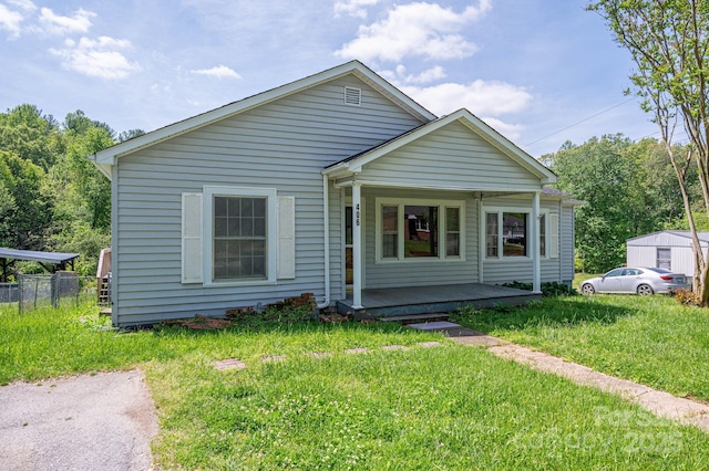 406 Arrowood St SE, Lenoir, NC 28645 - bungalow-style house with fence, covered porch, and a front yard