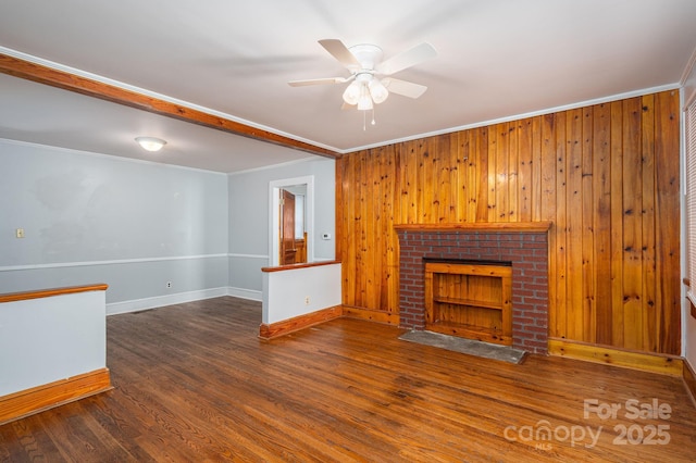 406 Arrowood St SE, Lenoir, NC 28645 - unfurnished living room featuring crown molding, wood finished floors, baseboards, ceiling fan, and wooden walls