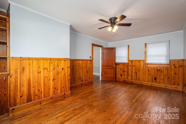 406 Arrowood St SE, Lenoir, NC 28645 - unfurnished room featuring wooden walls, ceiling fan, wainscoting, wood finished floors, and ornamental molding