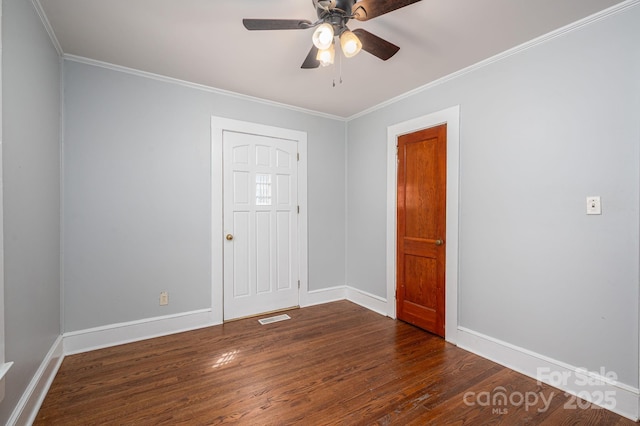 406 Arrowood St SE, Lenoir, NC 28645 - unfurnished room with baseboards, ornamental molding, dark wood finished floors, and visible vents