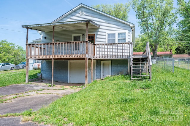 406 Arrowood St SE, Lenoir, NC 28645 - back of property with driveway, a wooden deck, stairway, fence, and a yard