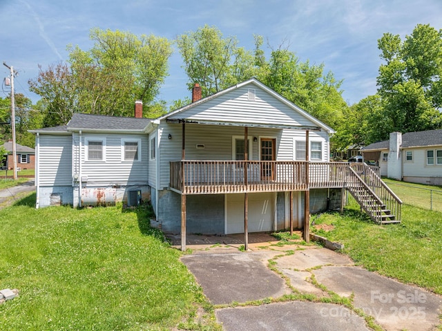 406 Arrowood St SE, Lenoir, NC 28645 - back of house with stairs, a deck, a chimney, central air condition unit, and a yard