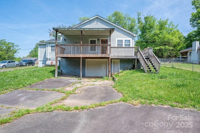 406 Arrowood St SE, Lenoir, NC 28645 - view of front of house with stairs, a front lawn, a wooden deck, and fence