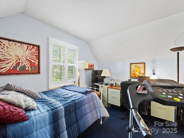 bedroom with lofted ceiling, dark colored carpet, and a textured ceiling