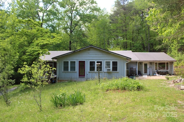 ranch-style home featuring board and batten siding and metal roof