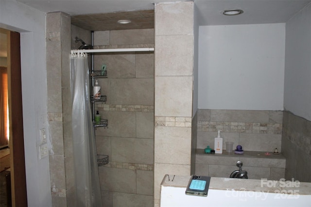 bathroom with tiled shower