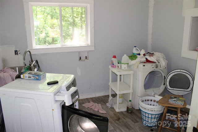 laundry area with baseboards, laundry area, washer / clothes dryer, and wood finished floors