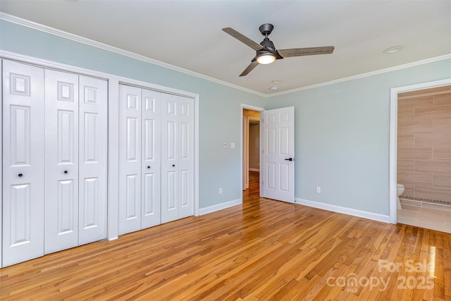 6007 Charing Pl, Charlotte, NC 28211 - unfurnished bedroom featuring light wood-style flooring, baseboards, two closets, crown molding, and ensuite bath