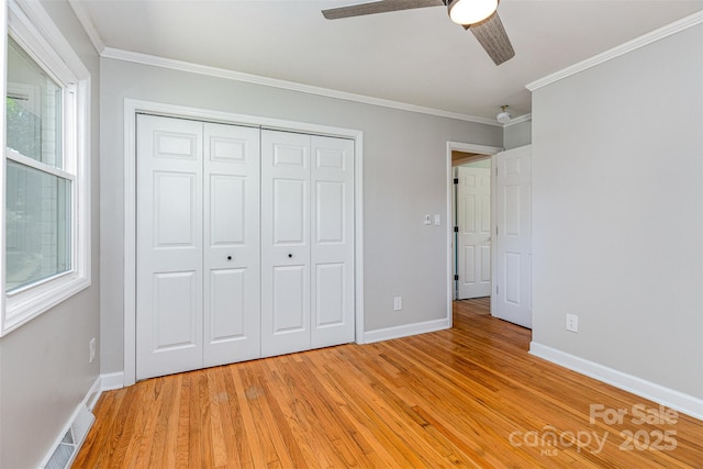 6007 Charing Pl, Charlotte, NC 28211 - unfurnished bedroom featuring ornamental molding, light wood-style floors, a closet, baseboards, and ceiling fan