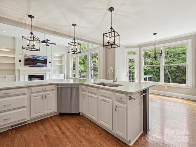 kitchen featuring stainless steel dishwasher, an inviting chandelier, a sink, and visible vents
