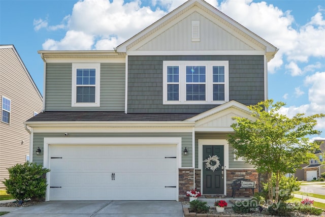 craftsman-style home with an attached garage and driveway