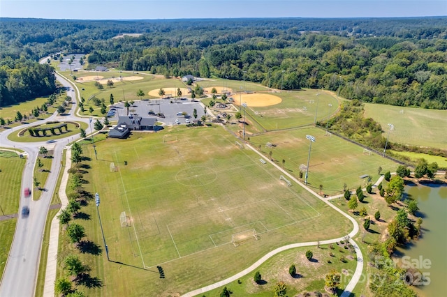 drone / aerial view featuring a water view and a wooded view