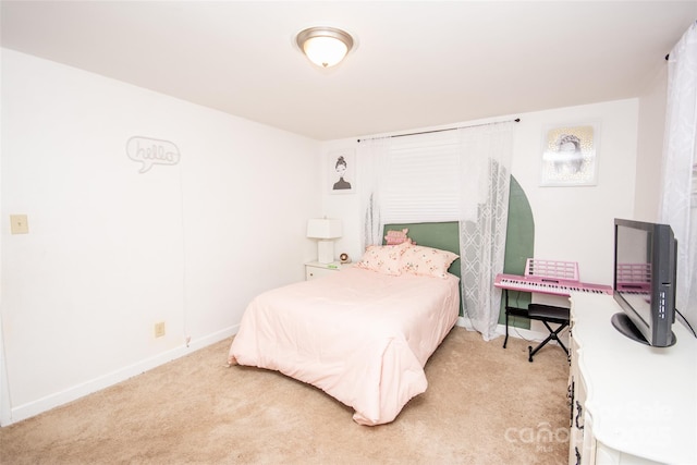 bedroom with baseboards and light carpet
