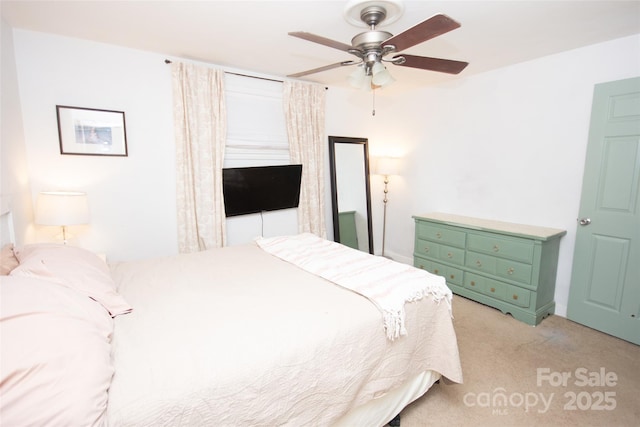 bedroom featuring a ceiling fan and light colored carpet