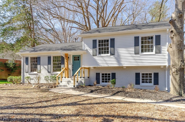 split level home featuring brick siding