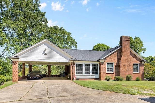 ranch-style house with roof with shingles, a front lawn, brick siding, a chimney, and concrete driveway