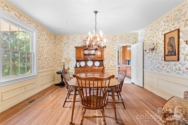 dining room featuring a notable chandelier, visible vents, a healthy amount of sunlight, and light wood-style flooring