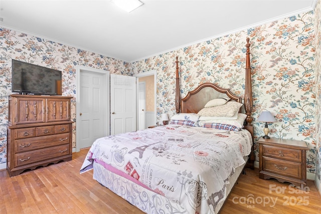 bedroom with crown molding, light wood-style flooring, and wallpapered walls