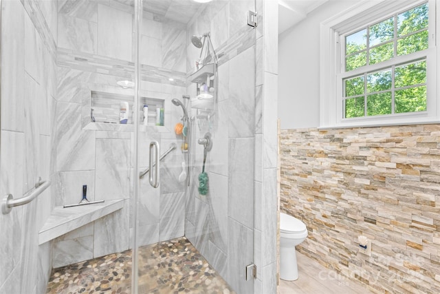 full bathroom featuring toilet and a shower stall