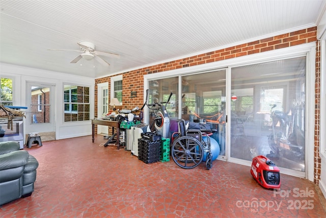 sunroom / solarium with a ceiling fan