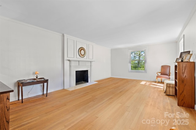 1574 Jarrett Farm Rd, Newton, NC 28658 - living room with a premium fireplace, baseboards, ornamental molding, and light wood-type flooring