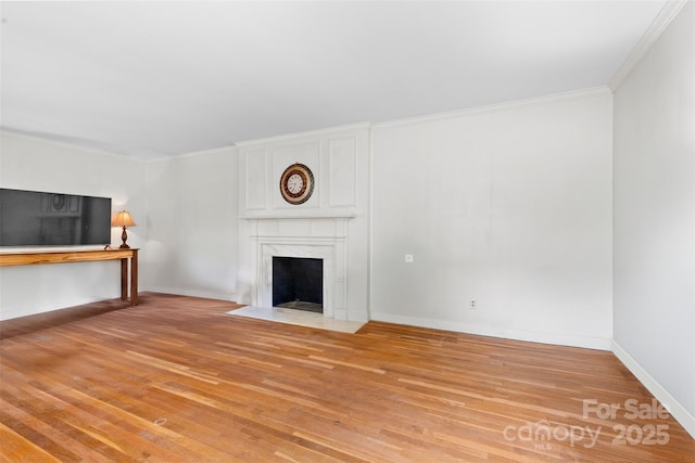 1574 Jarrett Farm Rd, Newton, NC 28658 - unfurnished living room with baseboards, a high end fireplace, light wood-style flooring, and ornamental molding
