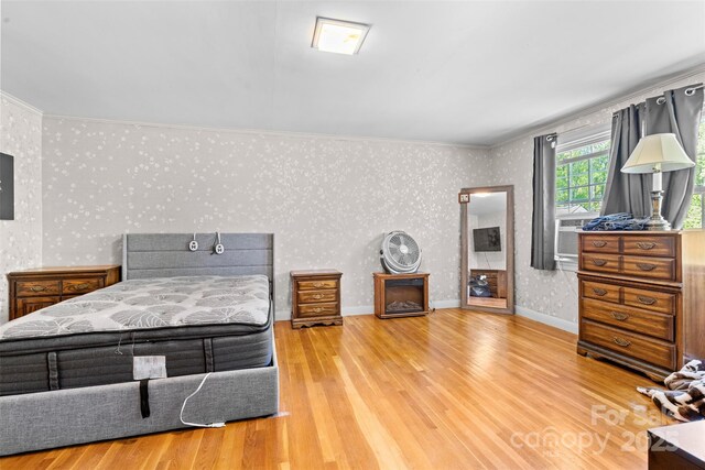 1574 Jarrett Farm Rd, Newton, NC 28658 - bedroom with crown molding, wallpapered walls, and wood finished floors