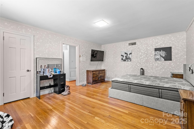 1574 Jarrett Farm Rd, Newton, NC 28658 - bedroom with crown molding, wallpapered walls, and wood finished floors