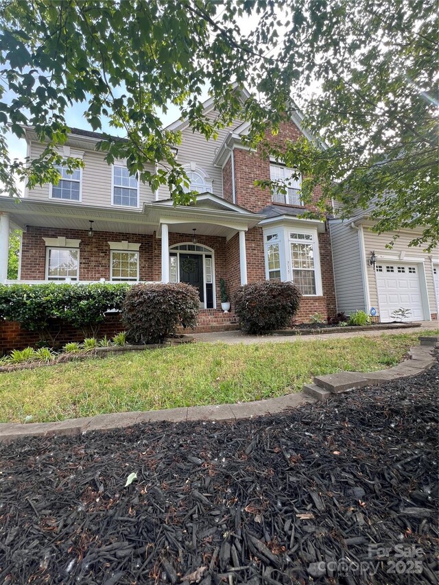 view of front of property with brick siding and an attached garage
