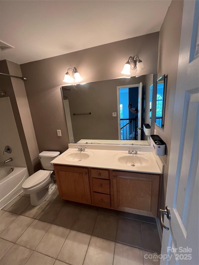 bathroom with tile patterned flooring, a sink, double vanity, and toilet