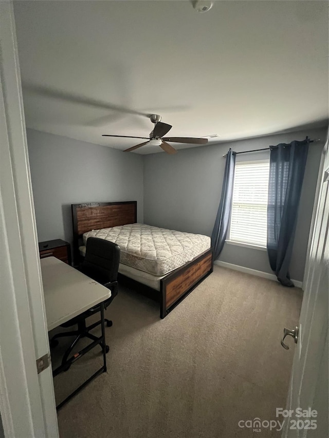 bedroom with baseboards, light carpet, and a ceiling fan