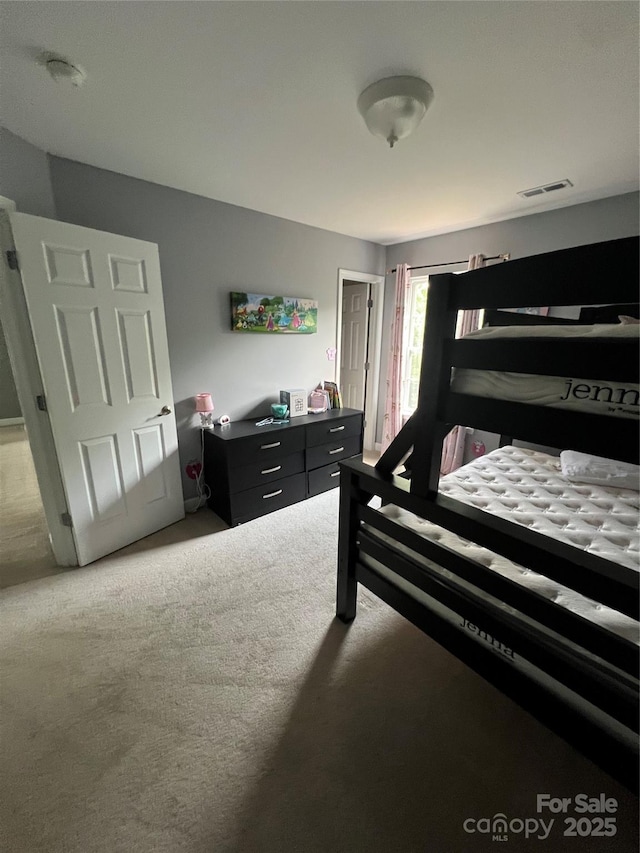 bedroom with visible vents and carpet floors