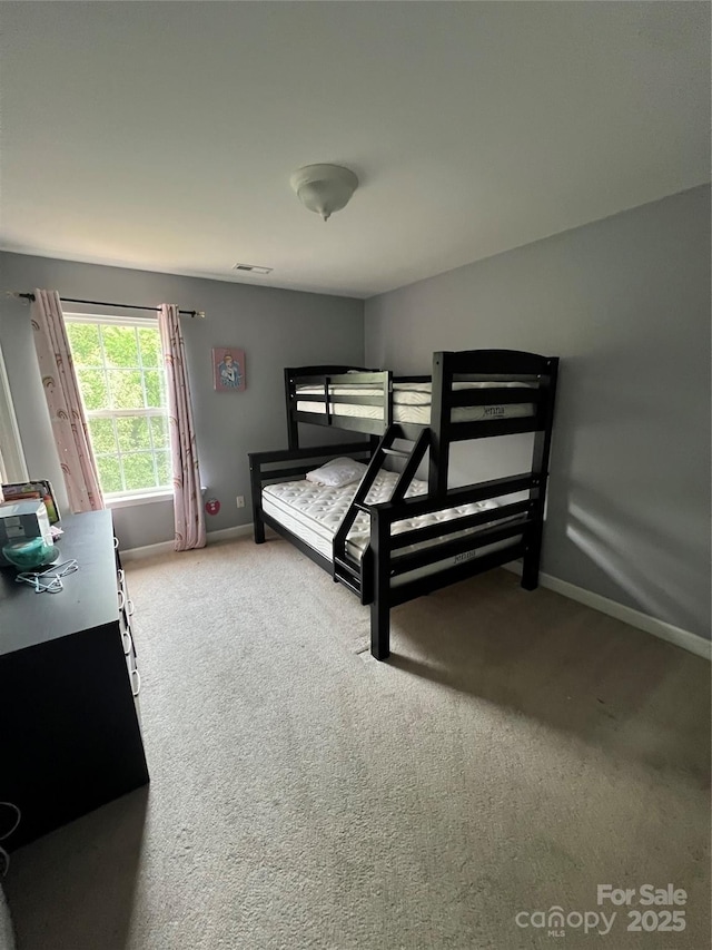 bedroom featuring visible vents, carpet, and baseboards