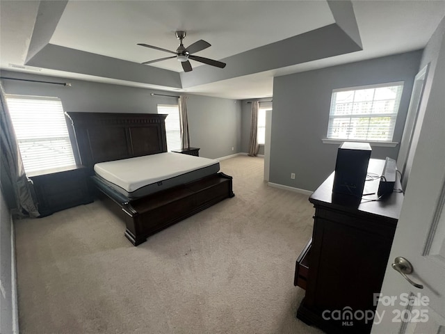 bedroom featuring a ceiling fan, baseboards, and light carpet