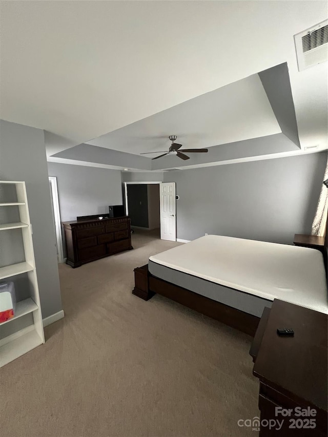 bedroom with baseboards, light colored carpet, ceiling fan, and visible vents