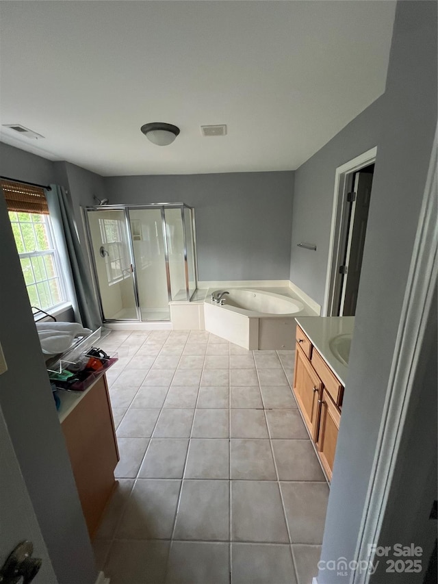 bathroom with visible vents, tile patterned floors, a stall shower, and vanity