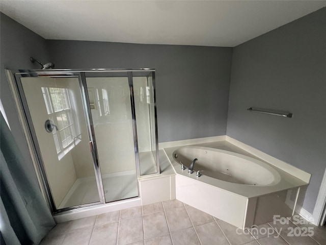 bathroom with tile patterned flooring, a whirlpool tub, and a shower stall