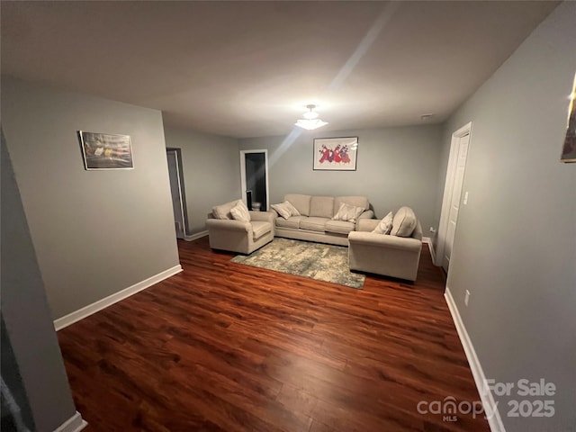 living room with baseboards and wood finished floors