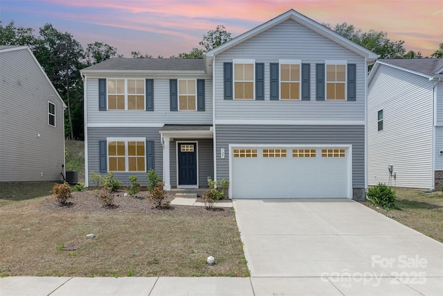 view of front facade featuring an attached garage, a lawn, central air condition unit, and concrete driveway