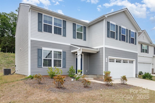 traditional-style home featuring a garage, central air condition unit, and driveway