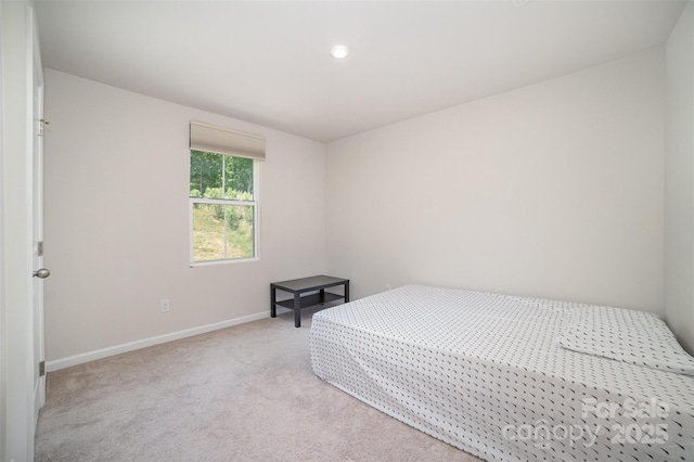 bedroom featuring baseboards, recessed lighting, and light carpet