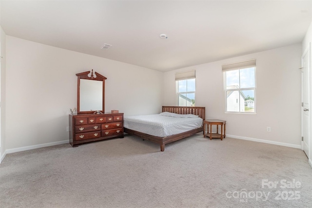 bedroom with carpet floors, baseboards, and visible vents