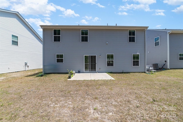 back of house featuring a lawn, a patio, and cooling unit