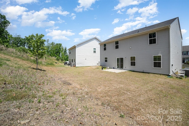 rear view of property featuring a lawn, a patio area, and central AC
