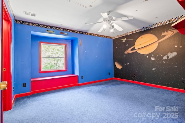 empty room featuring a ceiling fan, baseboards, visible vents, and carpet