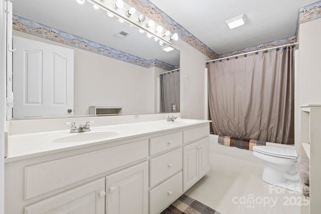 bathroom with visible vents, a sink, shower / bath combination with curtain, and double vanity