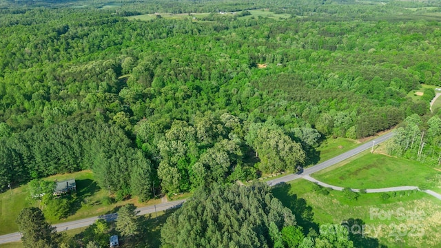 birds eye view of property featuring a wooded view