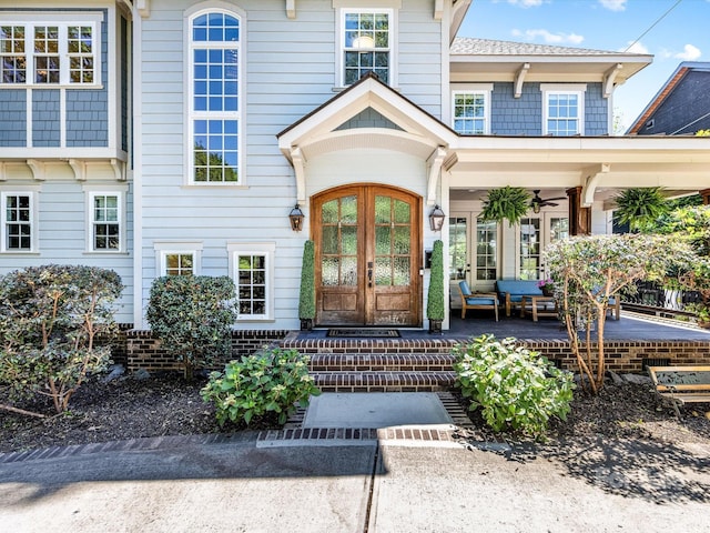 property entrance with a ceiling fan and french doors