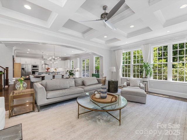 living area featuring coffered ceiling, ceiling fan with notable chandelier, recessed lighting, and beam ceiling